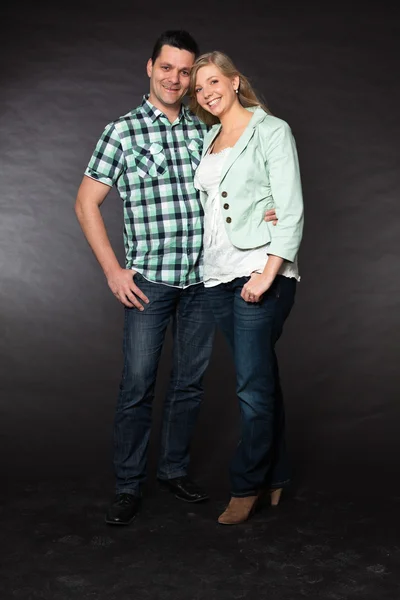 Couple in love. Studio shot against black. — Stock Photo, Image