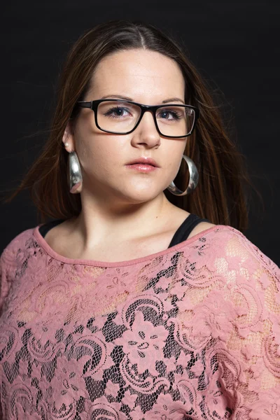 Pretty brunette girl against dark background. — Stock Photo, Image