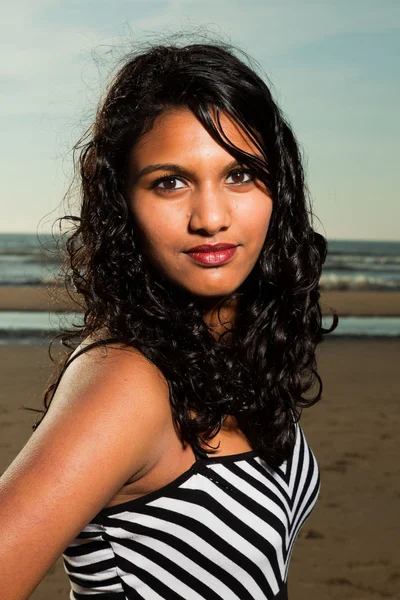 Pretty indian girl with long hair on the beach in summer. — Stock Photo, Image