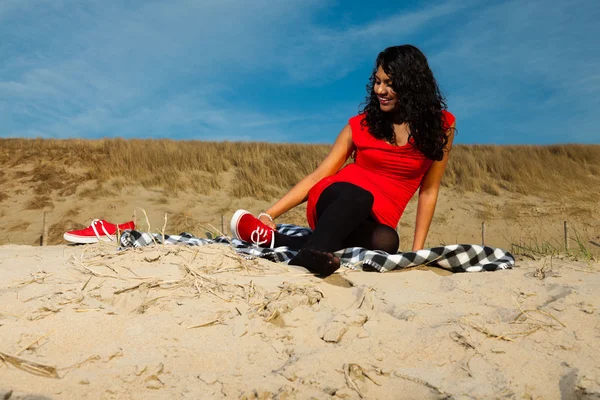 Indian girl with long hair dressed in red on the beach in summer — Stock Photo, Image