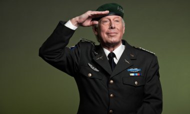 Military general wearing beret. Salutation. Studio portrait. clipart
