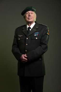 Military general in uniform wearing beret. Studio portrait. clipart