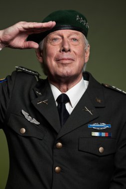 US military general wearing beret. Salutation. Studio portrait. clipart