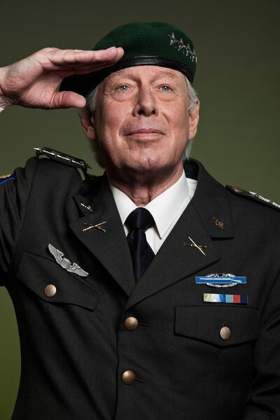 US military general wearing beret. Salutation. Studio portrait.
