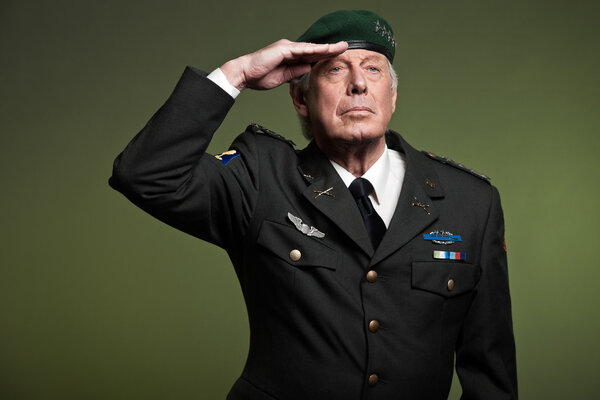 US military general wearing beret. Salutation. Studio portrait.