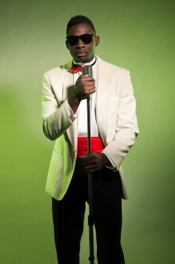 Singing black american man in suit wearing sunglasses. Vintage.