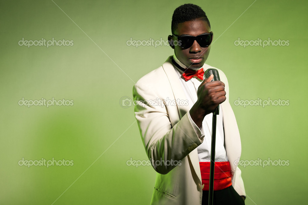 Singing black american man in suit wearing sunglasses. Vintage. Stock