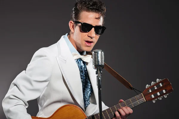 Retro rock and roll singer wearing white suit and black sunglass — Stock Photo, Image