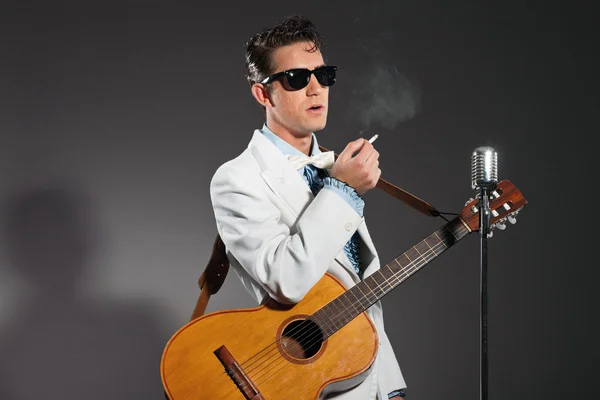 Retro rock and roll singer wearing white suit and black sunglass — Stock Photo, Image