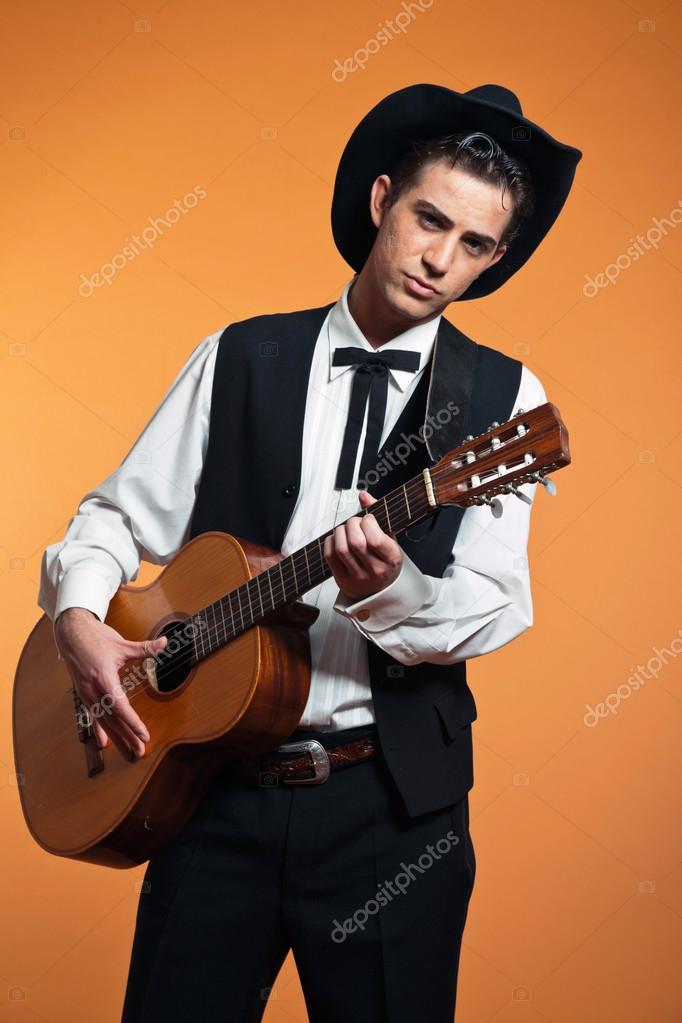 Retro country male guitar player wearing black suit and hat. Stu Stock Photo by ©ysbrand 25095445