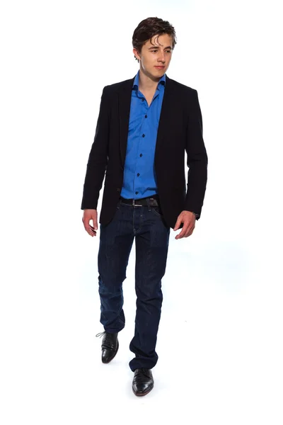 Walking young business man wearing blue jacket and jeans. Isolat — Stock Photo, Image