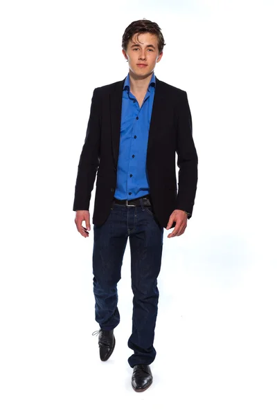 Walking young business man wearing blue jacket and jeans. Isolat — Stock Photo, Image