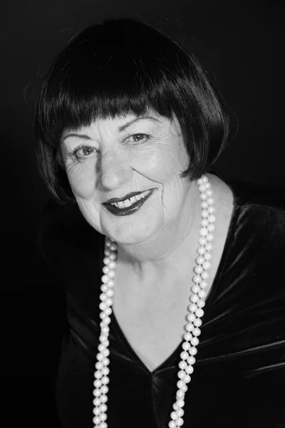Retro glamour studio portrait of senior woman. Black and white p — Stock Photo, Image