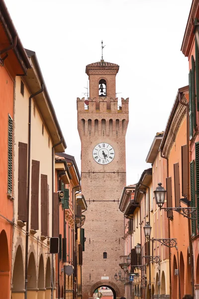 Street with houses and tower with clock in Castel San Pietro. Em — Stock Photo, Image