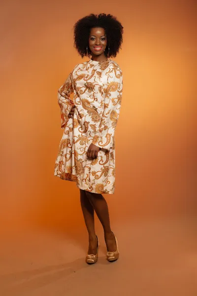 Happy retro seventies fashion african woman with paisley dress. — Stock Photo, Image