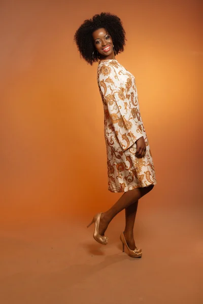 Happy retro seventies fashion african woman with paisley dress. — Stock Photo, Image