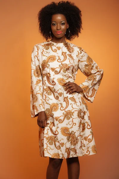 Gelukkig retro zeventig mode Afrikaanse vrouw met paisley jurk. — Stockfoto