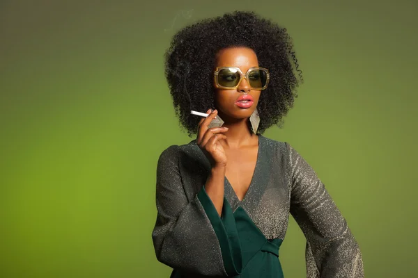 Fumer rétro 70s mode afro femme avec robe verte et sungla — Photo