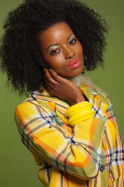 Afro woman in vintage seventies fashion style. Yellow jacket and — Stock Photo, Image