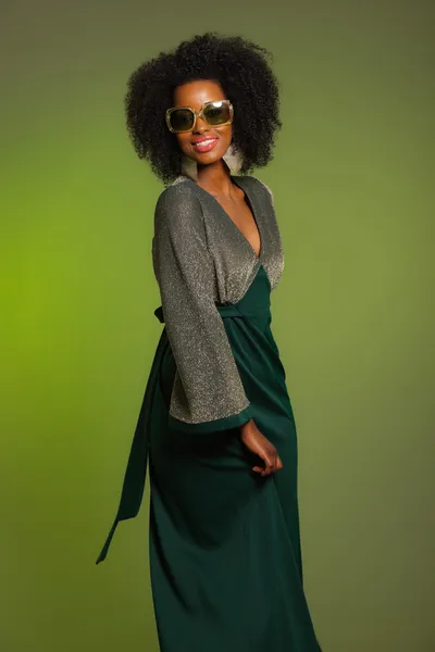 Dansende retro 70s mode afro vrouw met groene jurk en sungla — Stockfoto