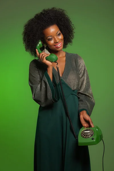 Retro 70s afro fashion woman with green dress. Calling with gree — Stock Photo, Image