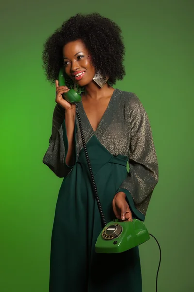 Retro 70s afro fashion woman with green dress. Calling with gree — Stock Photo, Image