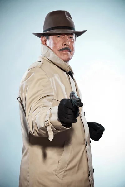 Vintage detective with mustache and hat. Holding gun. Studio sho — Stock Photo, Image