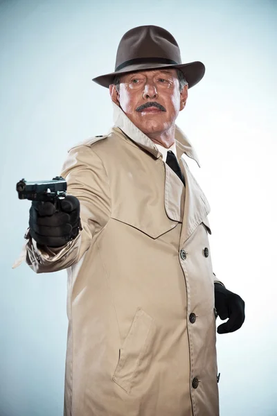 Vintage detective with mustache and hat. Holding gun. Studio sho — Stock Photo, Image