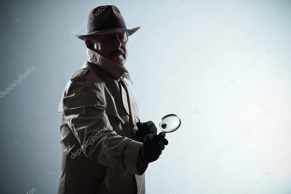 Silhouette of detective with mustache and hat. Holding magnifyin