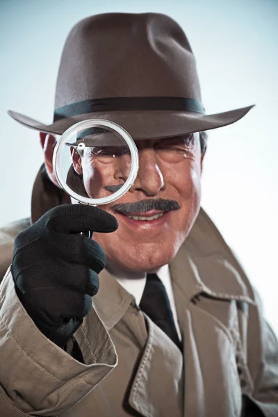 Vintage detective with mustache and hat. Looking through magnify — Stock Photo, Image