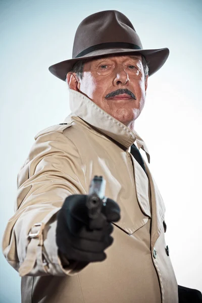 Retro-Detektiv mit Schnurrbart und Hut. Gewehr bei Fuß. Studioaufnahme. — Stockfoto