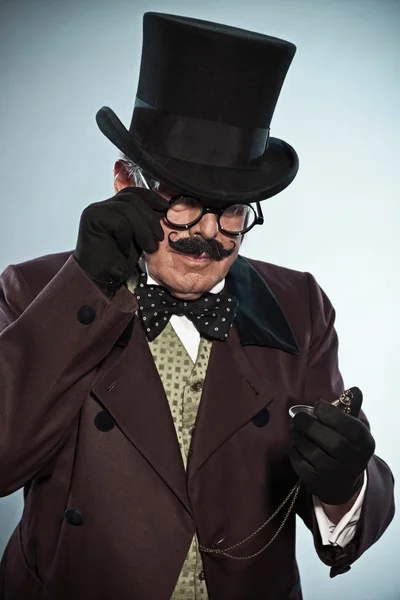 Retro dickens style man with mustache and hat. Looking at his an — Stock Photo, Image