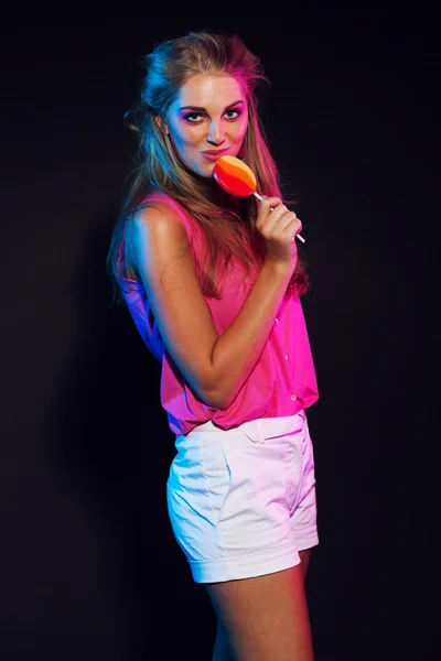Retro 80s fashion disco girl with blonde hair and lollipop. Blac — Stock Photo, Image