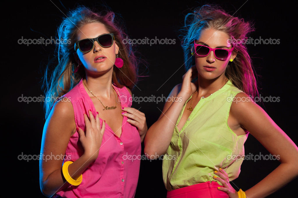 Two Sexy Retro 80s Fashion Girls With Long Blonde Hair And Sungl