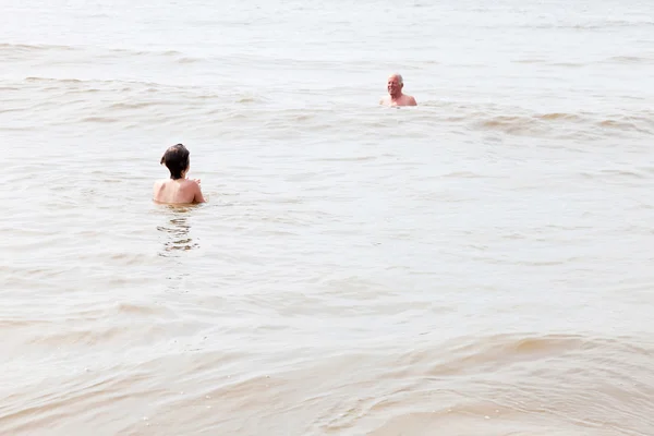 おじいちゃんの海で泳いでいる少年。波を楽しむ. — ストック写真