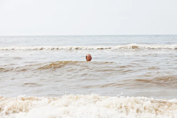 年轻的男孩在海中游泳。享受海浪. — 图库照片