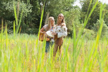 iki retro sarışın 70'lerin hippi kız müzik w yapma güneş gözlüklü