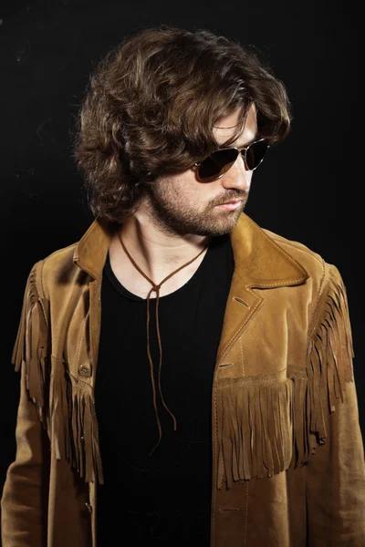 Cool rock style musician with long brown hair and beard. Wearing — Zdjęcie stockowe