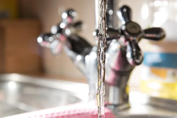 Close-up of water stream out of classic kitchen tap. — Stock Photo, Image