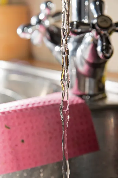 Close-up of water stream out of classic kitchen tap. — Stock Photo, Image