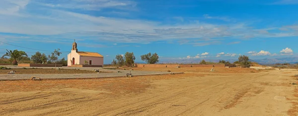 Panoramic abandoned landscape with one church and trees. Blue cl — Stock Photo, Image