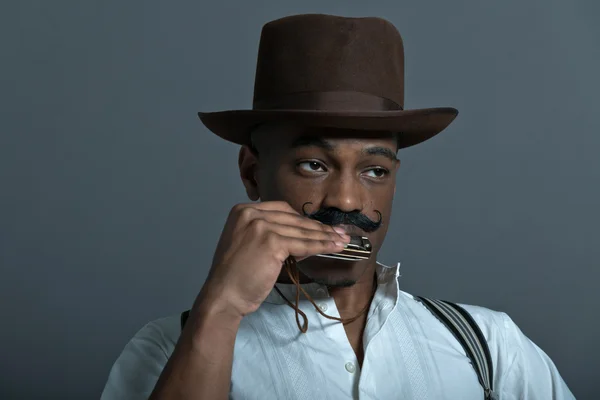 Harmonica playing retro afro america western cowboy man with mus — Stock Photo, Image