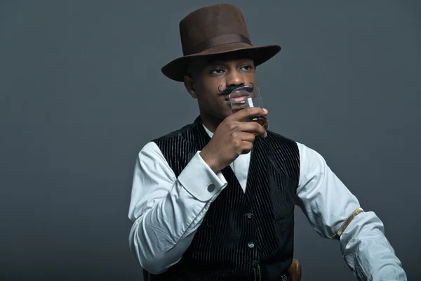 Vintage afro america western cowboy man with mustache. Drinking — Stock Photo, Image