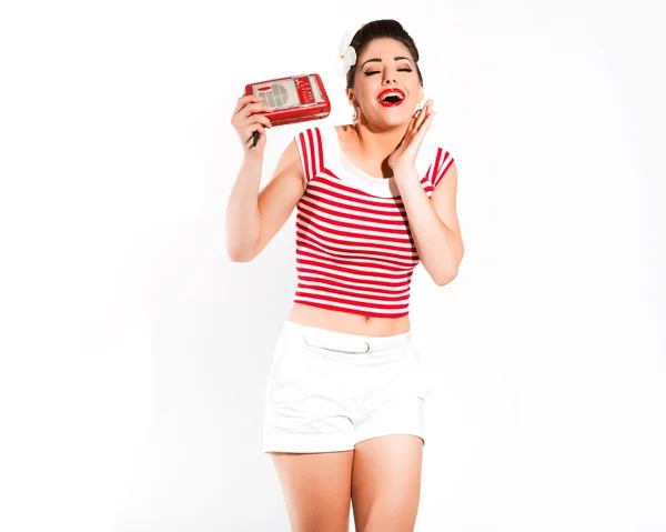 Sexy retro pin-up girl with radio and red lipstick wearing red s — Stock Photo, Image