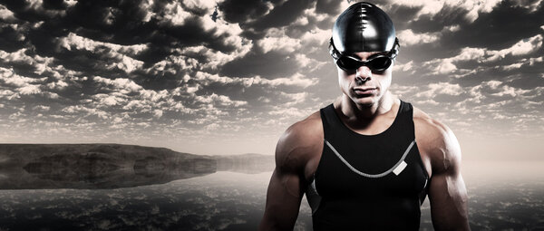 Swimmer triathlon man with cap and glasses outdoor at rough sea