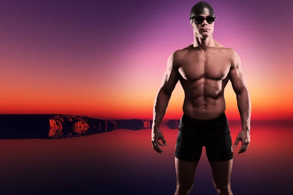 Muscled swimmer man with cap and glasses outdoor at a lake at su — Stock Photo, Image