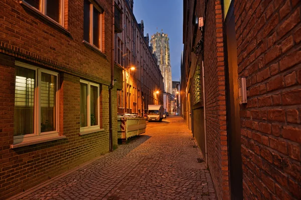 Street with church in the background at dusk. Sint-Rombout cathe — Stock Photo, Image