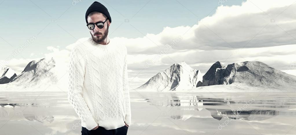 Cool man with beard in winter fashion. Wearing white woolen swea