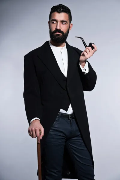 Retro hipster 1900 fashion man with black hair and beard. Smokin — Stock Photo, Image