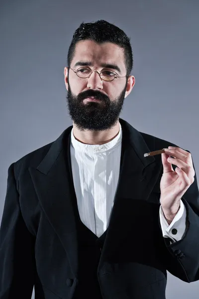 Retro hipster 1900 fashion man with black hair and beard. Smokin — Stock Photo, Image